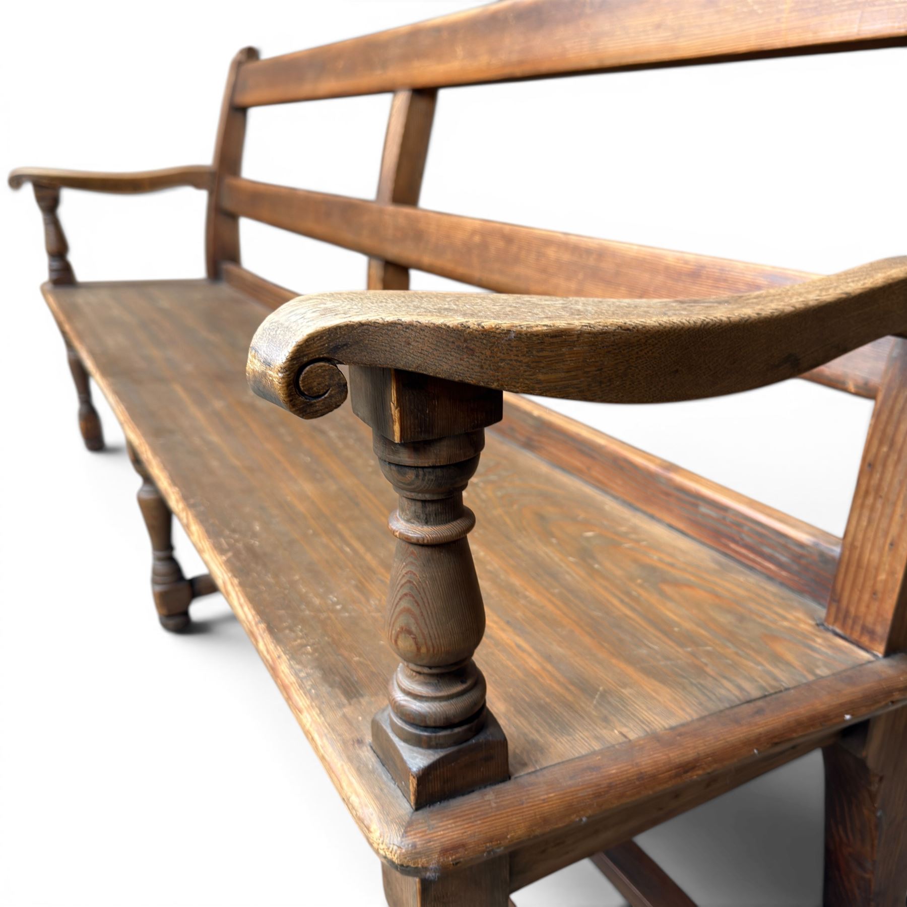 Early 20th century pine and oak bench seat, stained pine rail back frame with shaped oak arms