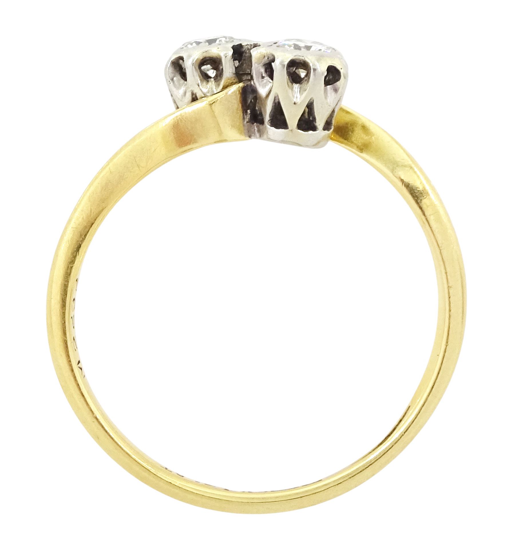 18ct gold diamond crossover ring, set with two round brilliant cut diamonds, Birmingham 1962, total diamond weight approx 0.25 carat