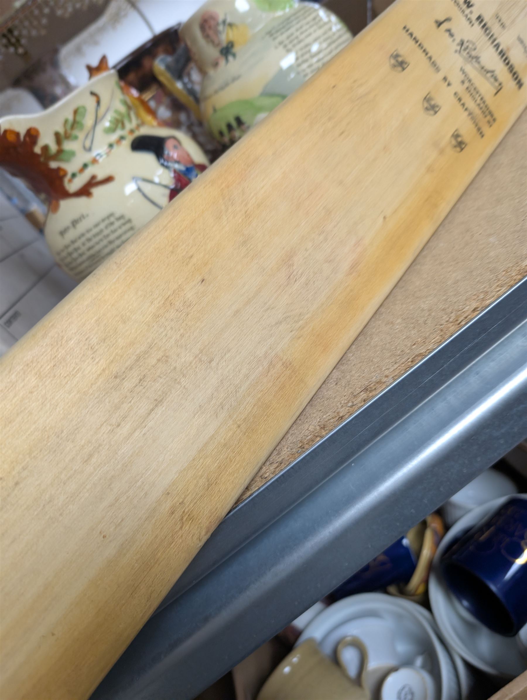 Two signed cricket bats, with signatures including Colin Cowdrey