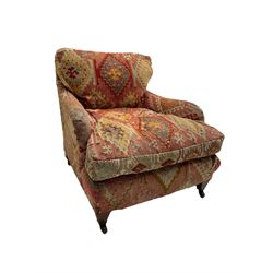 Early 20th century Howard style armchair, upholstered in Kilim fabric with sprung seat, hardwood frame, square tapering supports with brass and ceramic castors