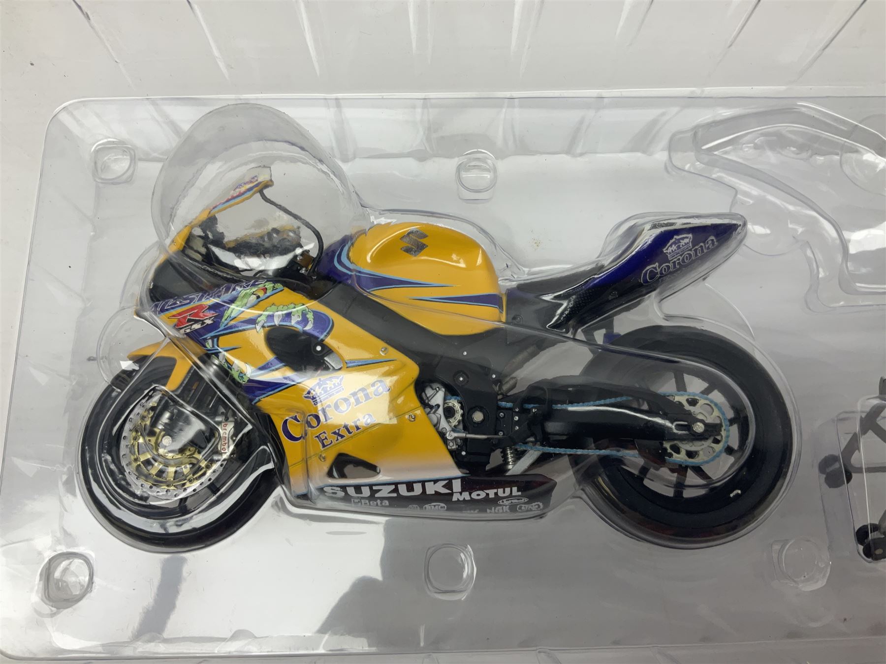 Three Minichamps 1:12 scale die-cast models of motorcycles - Suzuki GSX-R1000 Team Alstare Suzuki Corona Extra Troy Corser WSB 2005; Yamaha YZR-M1 Gauloises Yamaha Team Colin Edwards MotoGP Laguna Seca 2005; and Honda NSR 500 Loris Capirossi MotoGP 2002; all boxed (3)
