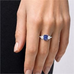 Platinum sapphire and diamond three stone ring, single emerald cut sapphire of approx 0.70 carat, either side set with two round brilliant cut diamonds, hallmarked, total diamond weight approx 0.50 carat