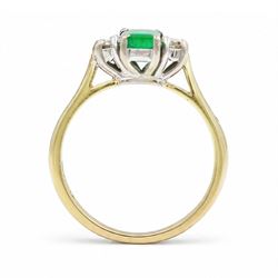 18ct gold emerald and diamond three stone ring, single octagonal cut emerald of approx 0.40 carat, with a round brilliant cut diamond set either side, Birmingham 1997, total diamond weight approx 0.15 carat