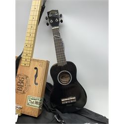 APC Carvalho acacia/koa and mahogany ukulele No.4030351 L66cm; small ukulele in speckled ebonised case; and a novelty three-stringed instrument as a simulated oblong cigar box labelled 'No.5 Blue Box Guitar'; all in carrying cases (3)