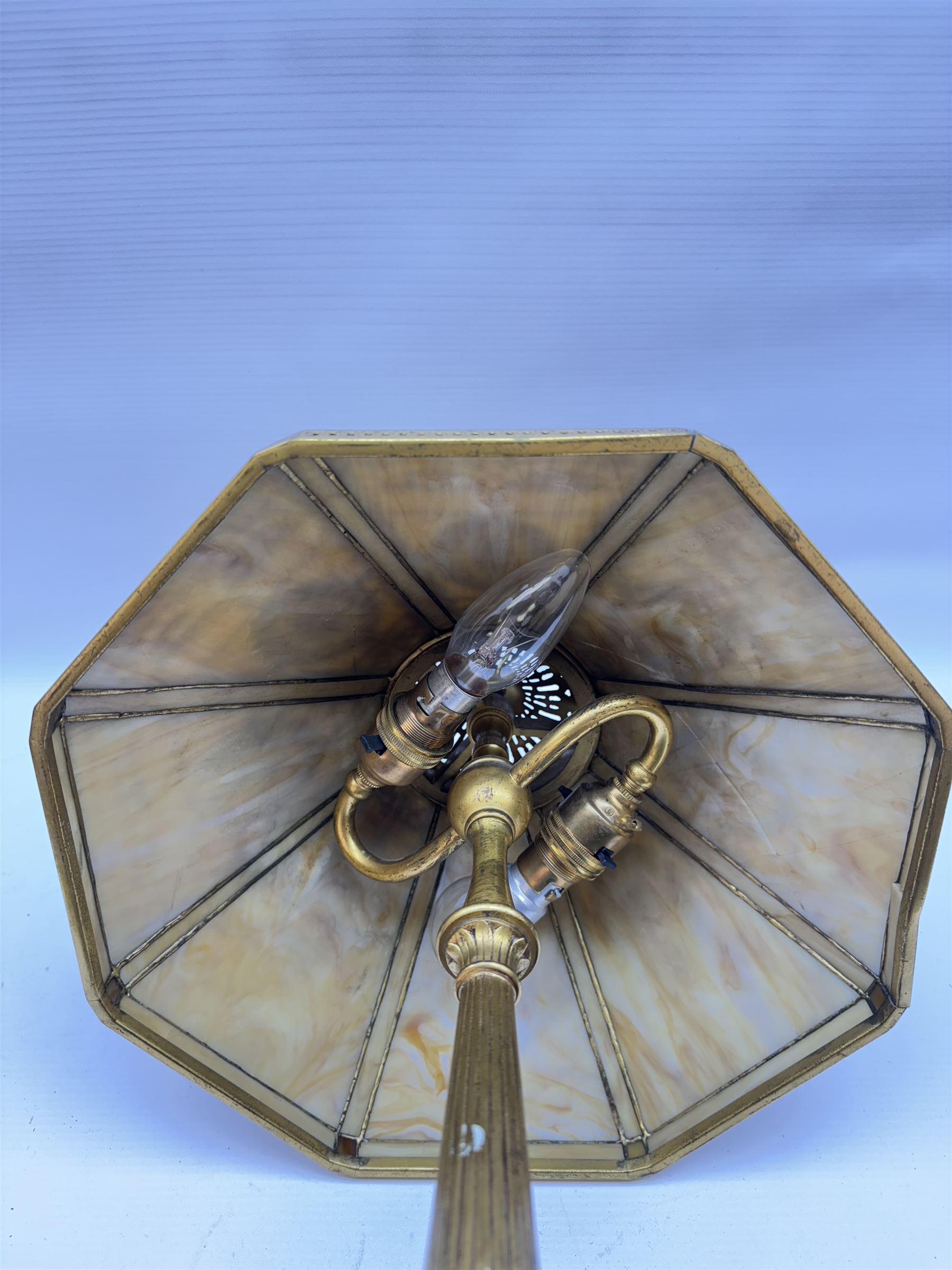 In the manner of Tiffany & Co, early 20th century gilt bronze Adam pattern table lamp, circa 1910, the circular spreading base decorated with flower heads and beaded bands, stiff leaves and husks, leading to a reeded column detailed with stiff leaves and swags, supporting a pierced octagonal shade, with original fittings, stamped beneath Tiffany Studios New York 539, overall H44.5cm


