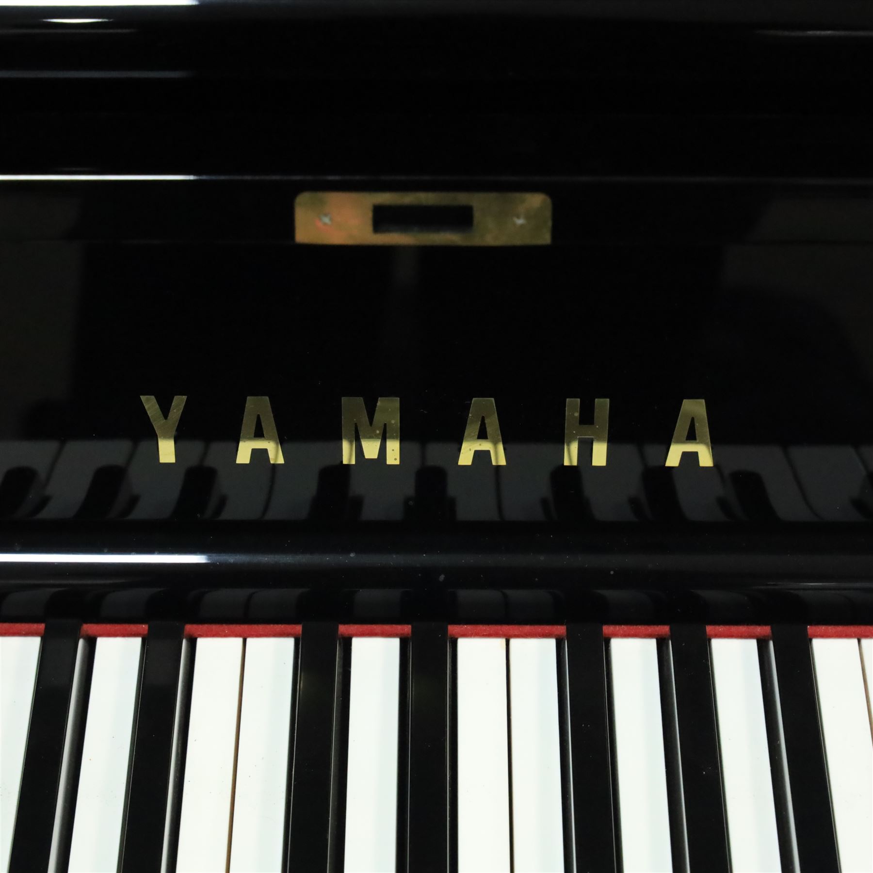 Yamaha model U5 upright piano retailed by Harrods, 88 keys and three pedals within high gloss ebonised case, serial no. 6055292, with Roland black button top piano stool