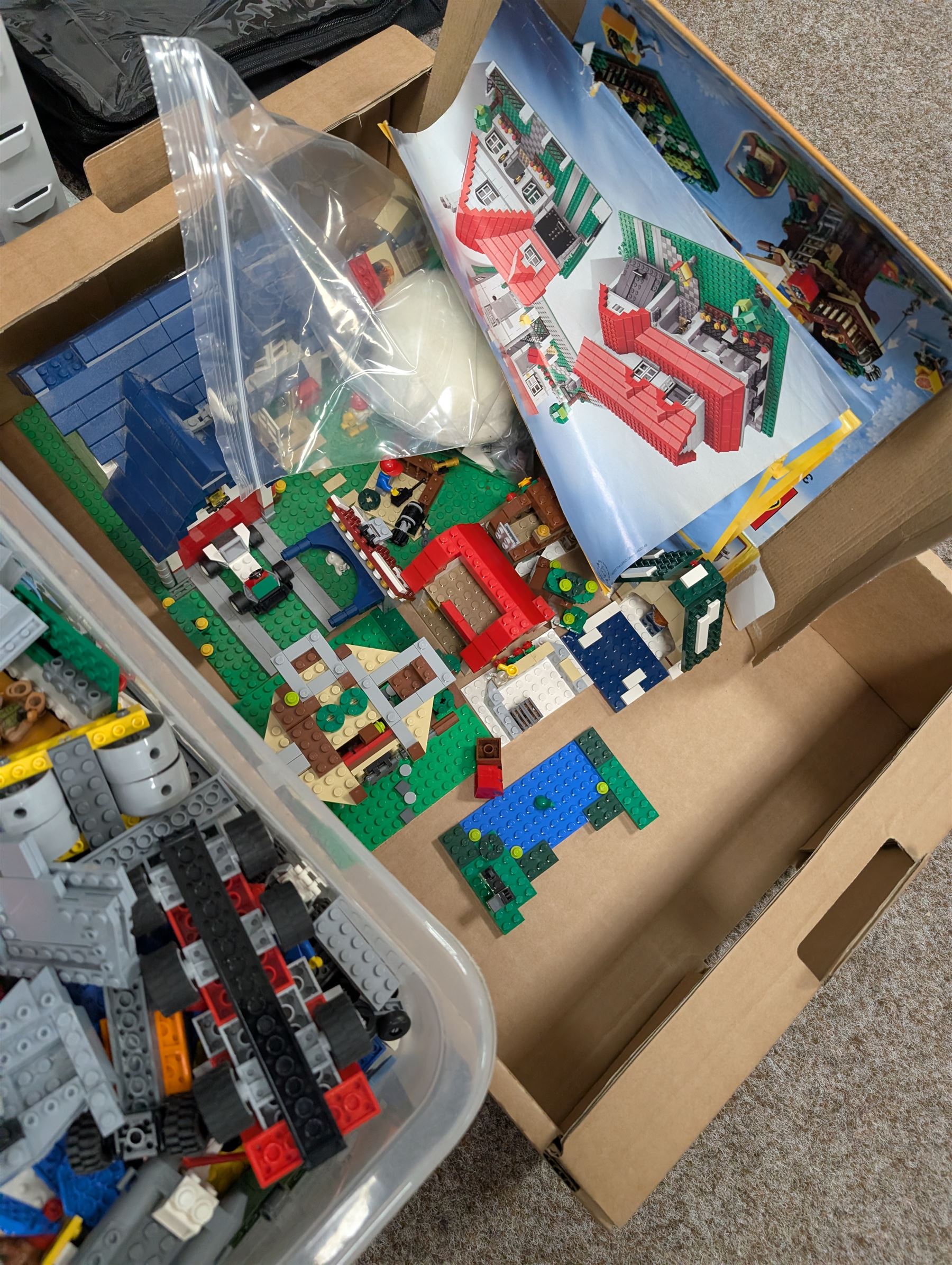 Large collection of Lego, including partially built vehicles, Police Station, Lego Creator 31010 and a collection of Lego instruction booklets
