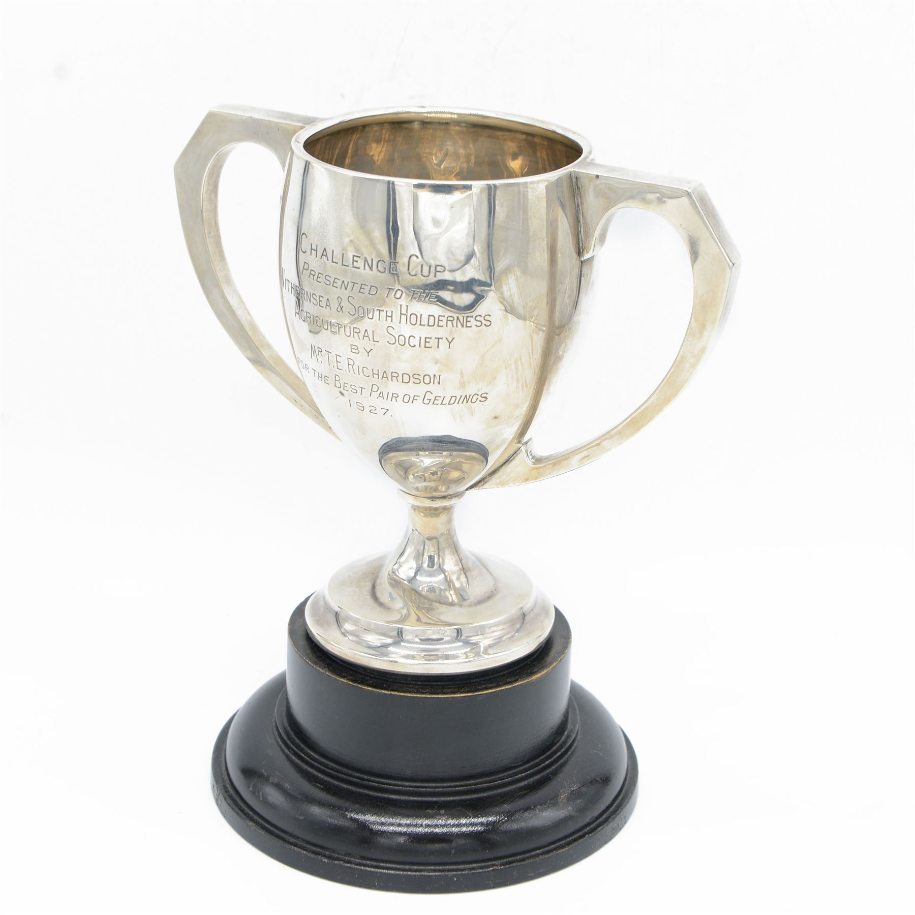 1920s silver twin handled trophy with engraving to body, upon circular foot and ebonised wooden plinth, total height H20cm