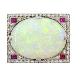 Art Deco platinum opal, diamond and ruby brooch, the cabochon oval opal surrounded by pave set diamonds and four rubies at each corner

Notes: By direct decent from Barraclough family