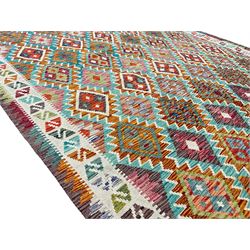 Anatolian Turkish Kilim multi-colour rug, decorated with all over lozenges in contrasting colours with ivory outline, the multi-band ivory border with repeating geometric shapes and small lozenges or diamonds