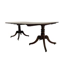 Early 19th century mahogany extending dining table, the two D-ends each with moulded rectangular tops on turned pedestals with four carved splayed supports, decorated with draught turned roundels, ornate cast brass cups and castors, with additional leaf