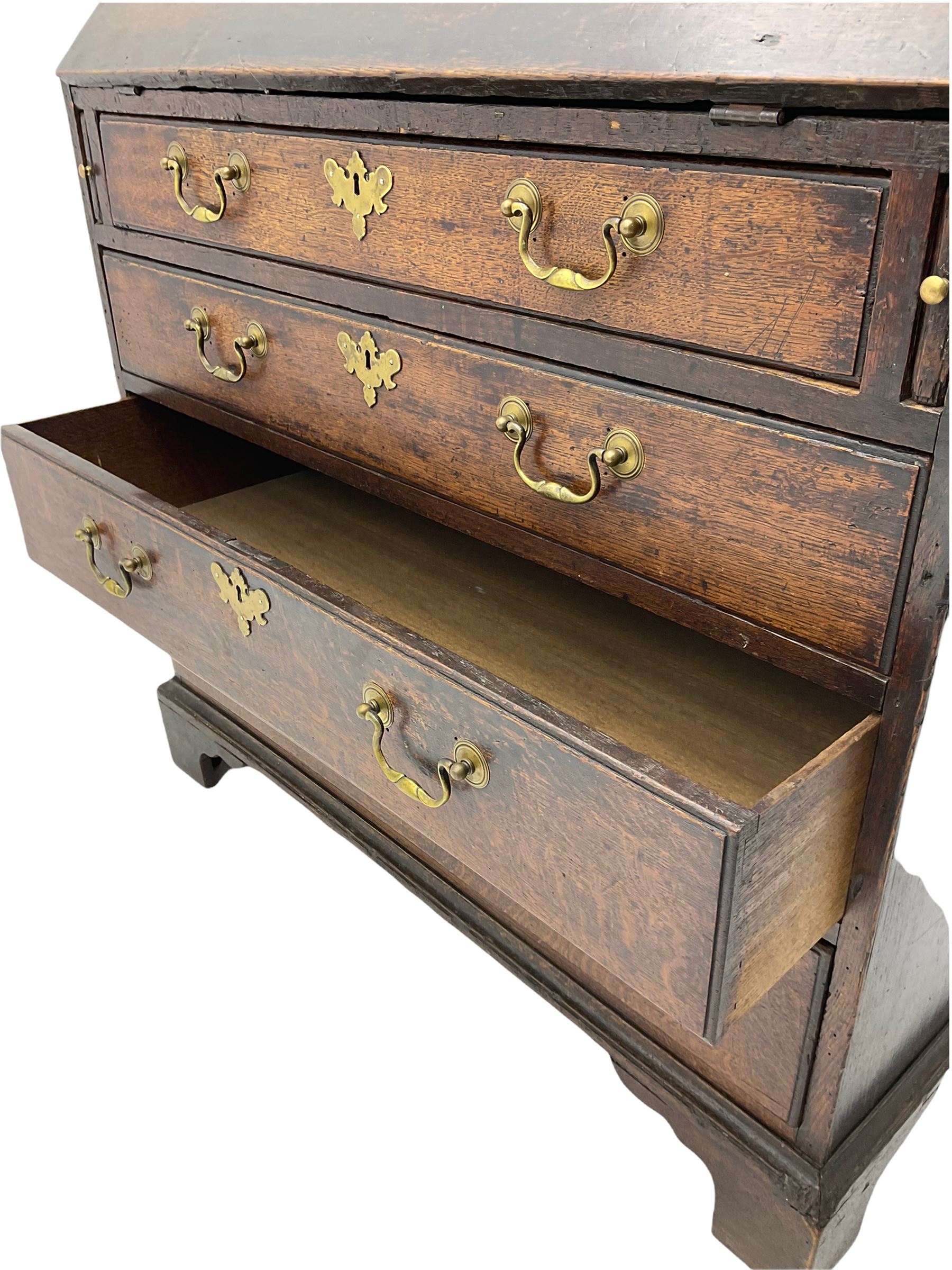 Georgian oak bureau, fall front enclosing fitted interior, four long graduating drawers, on bracket feet