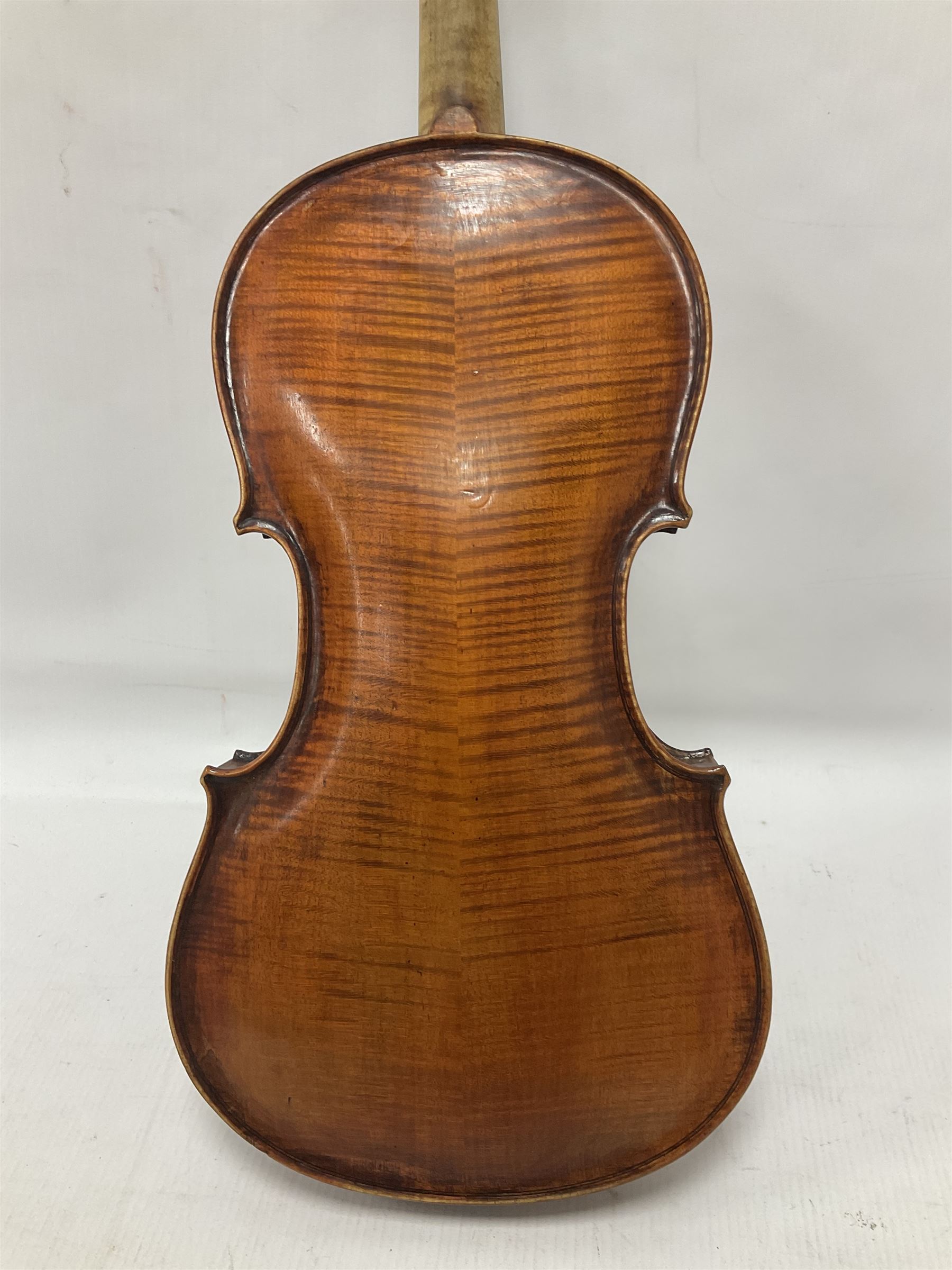 19th century full sized violin in a later hard case, decorative mother of pearl inlay to the tail piece Overall length 60cm No bow