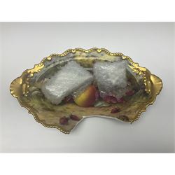 Early 20th century Royal Worcester dish decorated by Thomas Lockyer, oval form with gilt shaped rim and twin shell handles, hand painted with a still life of fruit upon a mossy ground, signed T Lockyer, with puce printed mark beneath and date code for 1922, for restoration, W31cm