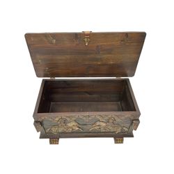 Carved wooden blanket chest, the tooled hinged lid with shaped metal strap hinges and catch, the front carved with arcade over two medieval jousters, on carved sledge feet