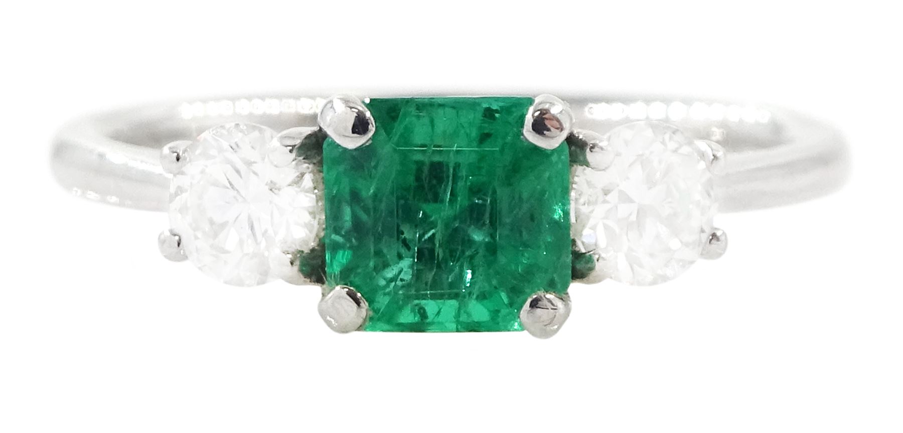 18ct white gold emerald and diamond three stone ring, single modified square cut emerald of approx 0.65 carat, with a round brilliant cut diamond set either side, hallmarked, total diamond weight approx 0.35 carat