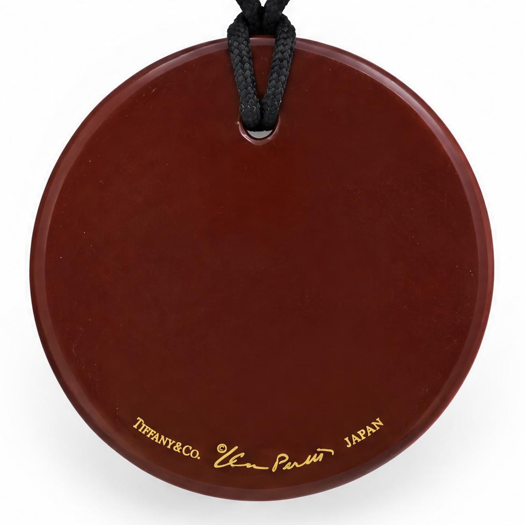 Tiffany & Co. red lacquer on Japanese hardwood round pendant necklace, on black silk cord by Elsa Peretti, signed 