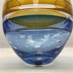 Stuart Akroyd glass vase, yellow banded top and blue lower section with bubble inclusions, with sticker and engraved signature beneath, H17cm