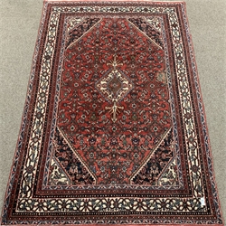 Large Persian red ground rug, central medallion, repeating border, 315cm x 210cm