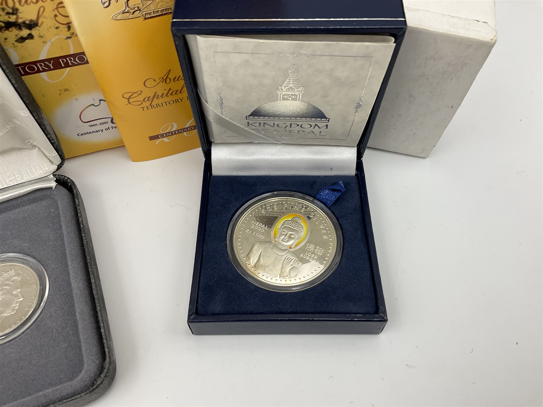 The Singapore Mint 2000 sterling silver proof one thousand five hundred Rs coin and an Australian Centenary of Federation 2001 three- coin set, both cased with certificates