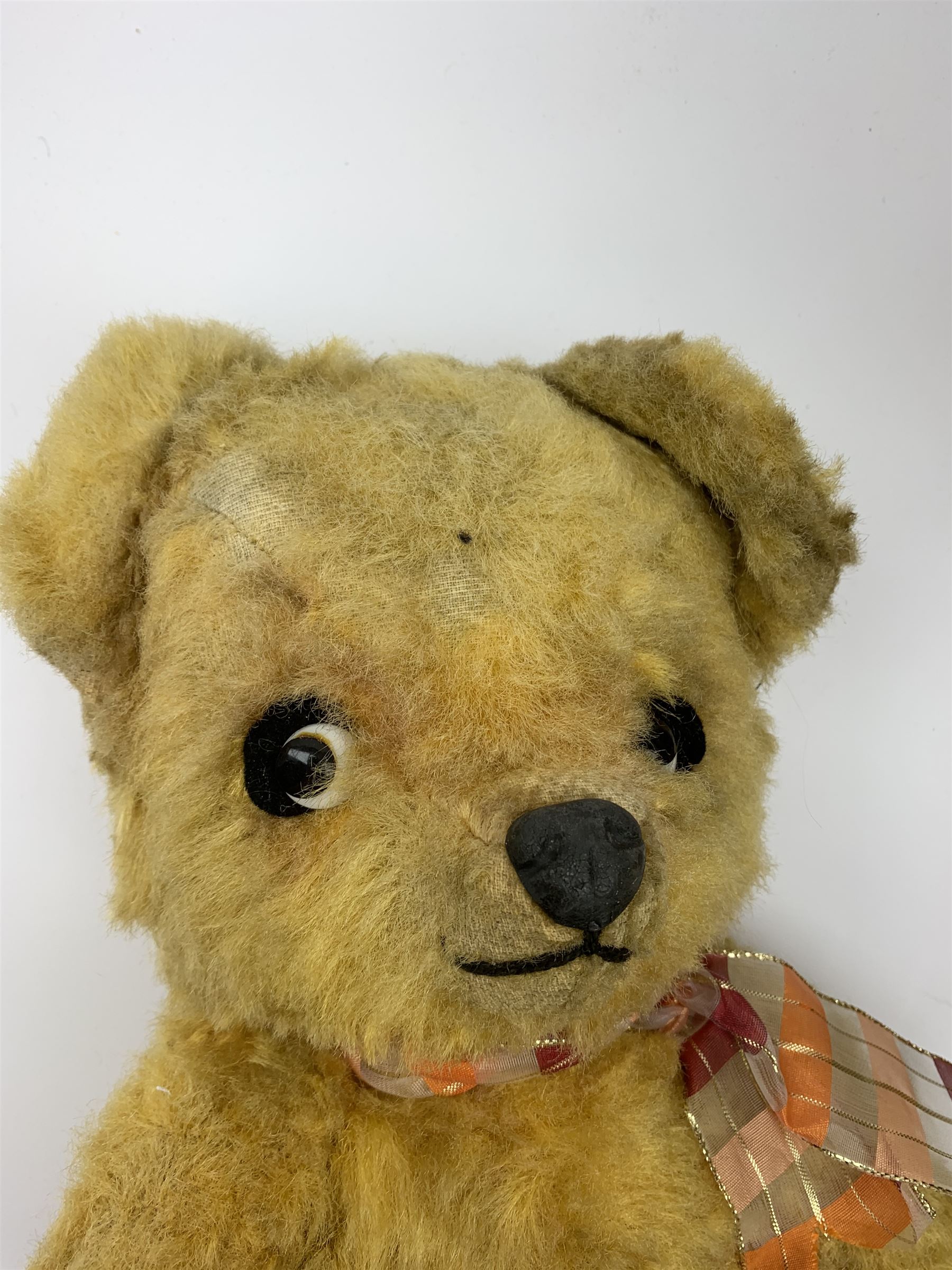 1950s English large wood wool filled teddy bear with swivel jointed head, glass type eyes and vertically stitched nose and mouth and jointed limbs with rexine paw pads H33