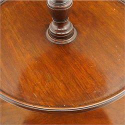 George III mahogany dumb waiter, three graduating circular tiers with moulded edges, turned column supports on tripod base, on castors 