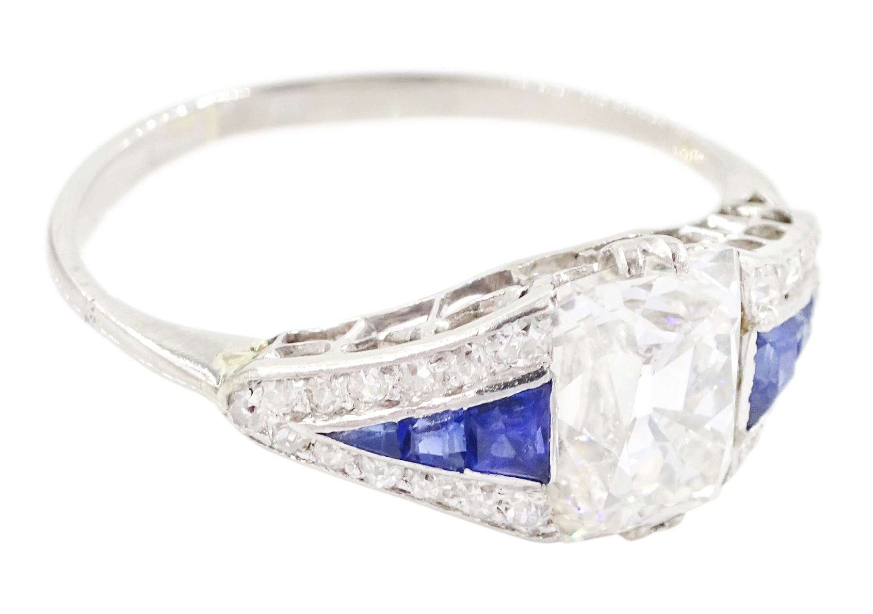 Platinum diamond and sapphire ring, the principal old cushion cut diamond of approx 1.50 carat, each side set with three graduating calibre cut sapphires and old cut diamond surround