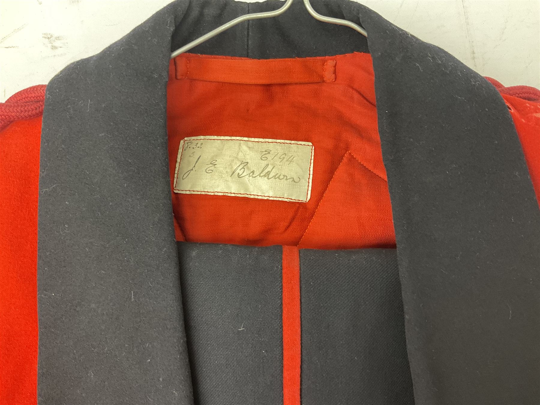 Royal Military College Sandhurst parade uniform with peaked cap and two-piece mess dress, all bearing historic manuscript labels for J.E.A. Baldwin, possibly Air Marshal Sir John Eustace Arthur Baldwin (1892-1975) who served in the British Army 1910-18 & 1944-58 and in the RAF 1918-44.