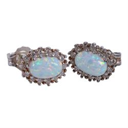 Pair of silver opal stud earrings, pair of silver blue opal stud earrings, pair of silver rose gilt cubic zirconia hoop earrings, silver ruby and opal ring, and silver gilt tourmaline ring