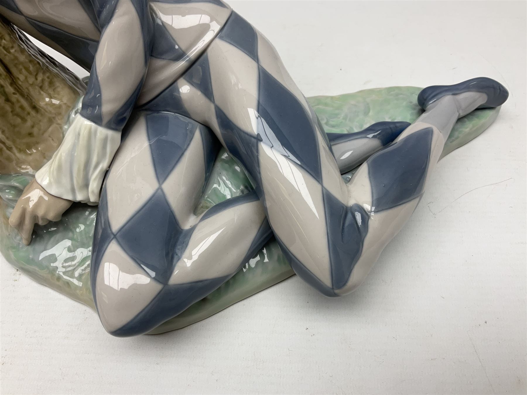 Lladro figure, Harlequin Reclining, modelled as a recumbent harlequin, no 5128, Sculpted by Salvador Furio, year issued 1982, year retired 1987, H28cm 