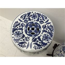 Pair of Chinese blue and white garden seats, each of barrel form, decorated with dragon and phoenix amidst flowering vines, each upon a hardwood stand with five curved legs, seats H45cm D29cm including stand H68cm