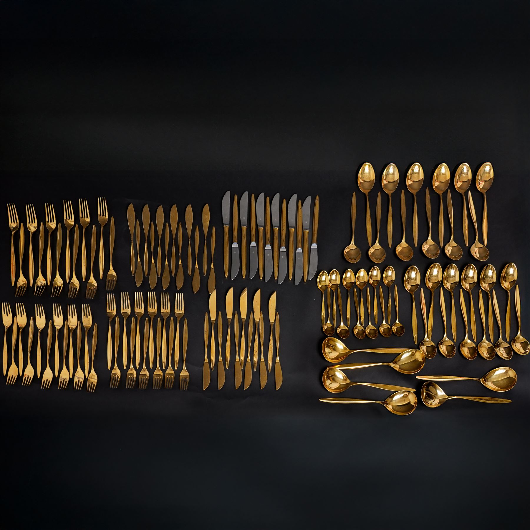 Extensive suite of WMF 800 silver gilt cutlery, for twelve covers, comprising twelve table knives and forks, fish knives and forks, dessert forks, table spoons, dessert spoons, teaspoons, eleven dessert forks and six serving spoons, with crescent moon and crown WMF hallmarks