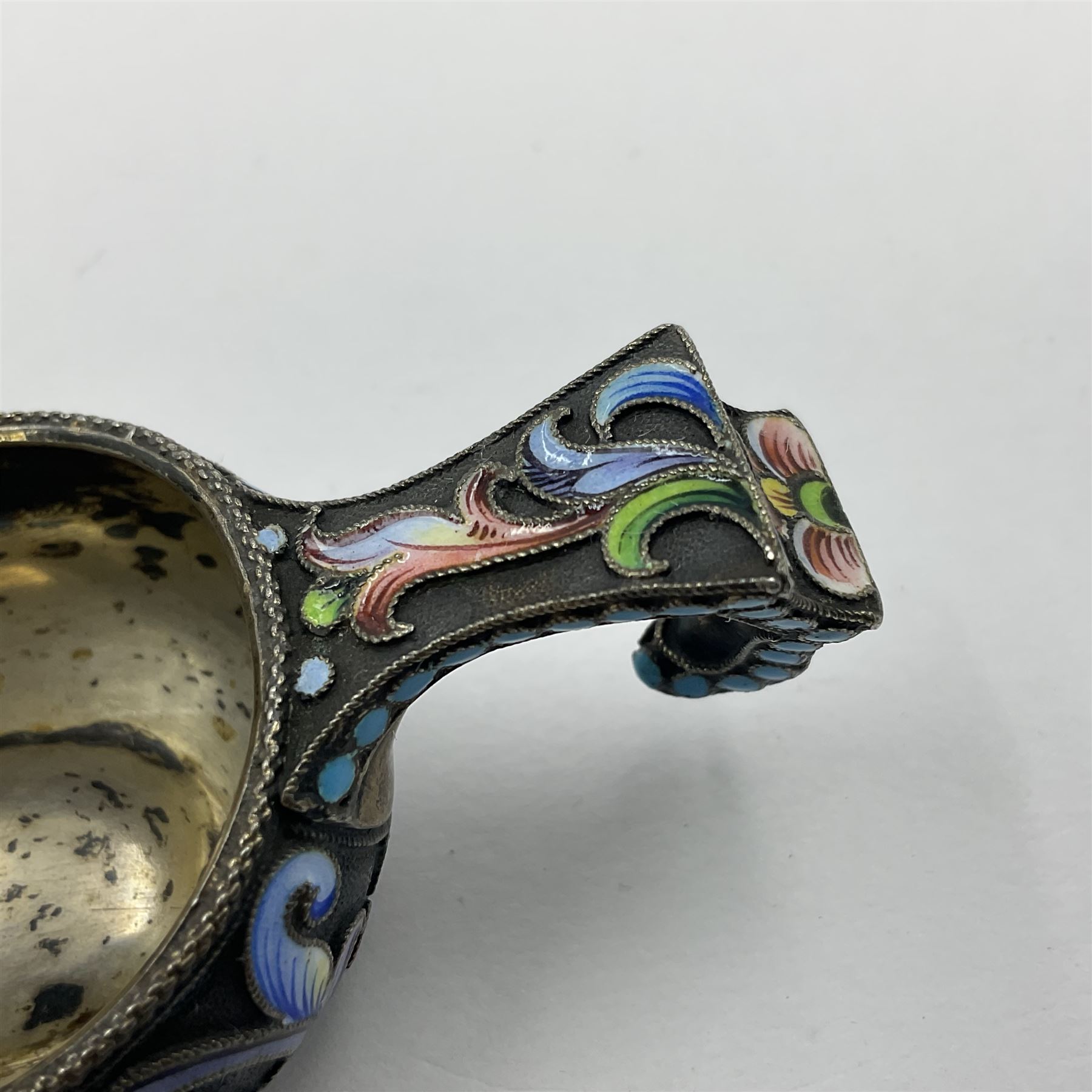 Late 19th century Russian silver kovsh, the body with polychrome cloisonne enamel floral decoration and turquoise enamel bead borders to base and handle, marked beneath with Kokoshnik mark, 84 standard, makers mark MC, possibly for Mikhail Fyodorovich Sokolov, L7cm, H3cm