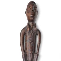 African Colonial carved hardwood staff finial, the male figure in military dress, L66cm, African Fang weaving tool and a woven basket (3)