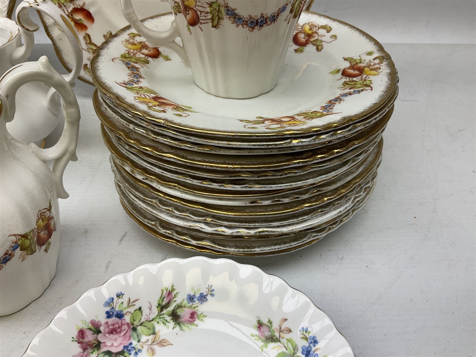 Quantity of Royal Albert tea wares to include 'Moss Rose' teapot, sucrier and saucers, together with teacups, saucers, side plates, jug etc decorated with orange, yellow and blue floral sprays with gilding upon plain ground, all stamped Royal Albert beneath