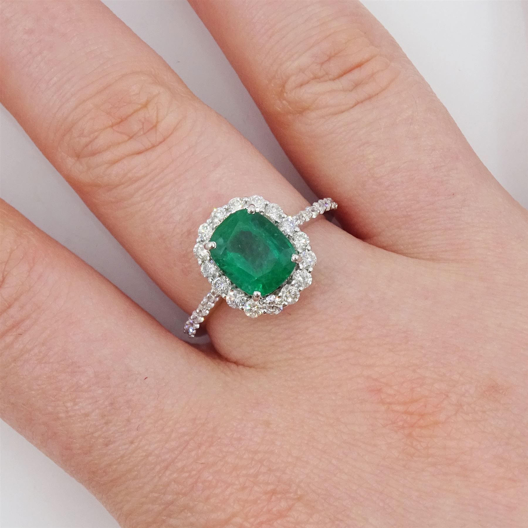 18ct white gold cushion cut emerald and round brilliant cut diamond cluster ring, with diamond set shoulders, stamped, emerald approx 2.30 carat