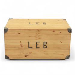 Pine storage trunk, of rectangular plank construction with metal corner protectors and stencilled lettering ‘LEB’ to front and lid