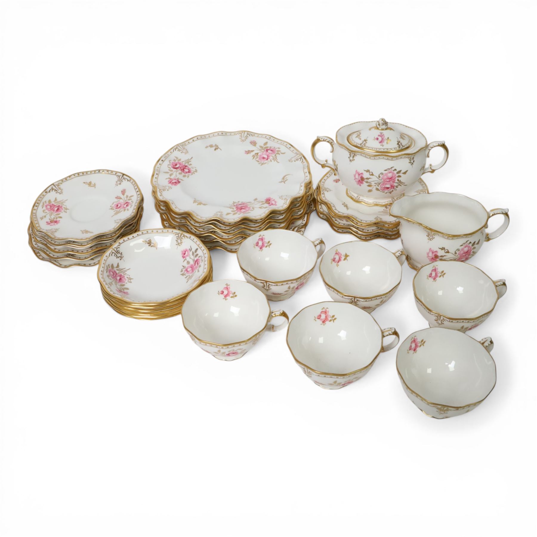Modern Royal Crown Derby tea set for six place settings, decorated in the Royal Pinxton Roses pattern, comprising tea cups, saucers, small dishes, side plates, dessert plates, one serving plate, twin handled lidded sucrier and milk jug