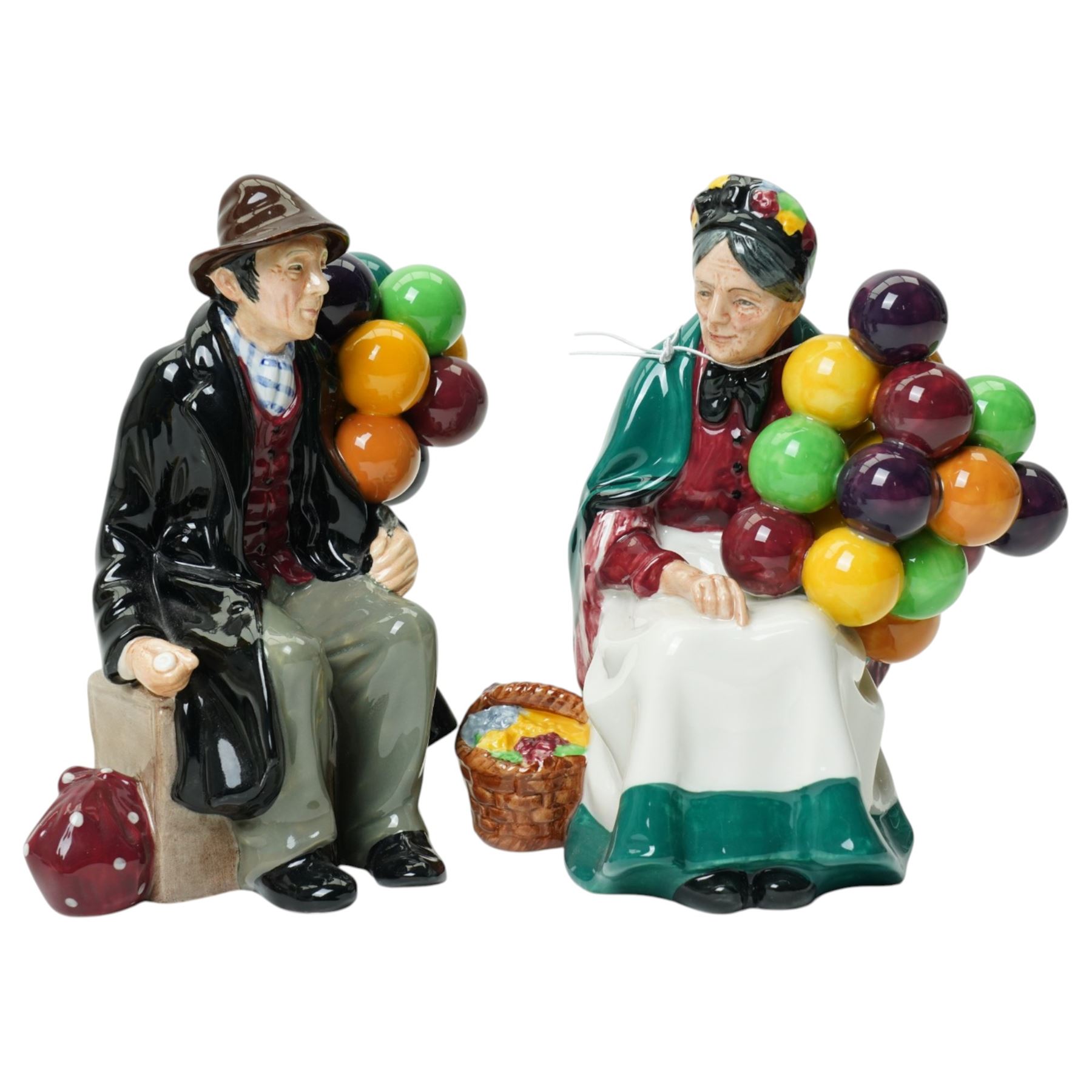 Royal Doulton figures comprising The Old Balloon Seller HN1315, The Balloon Man HN1954, Biddy Pennyfarthing HN1843 and Balloon Girl HN2418 (4)