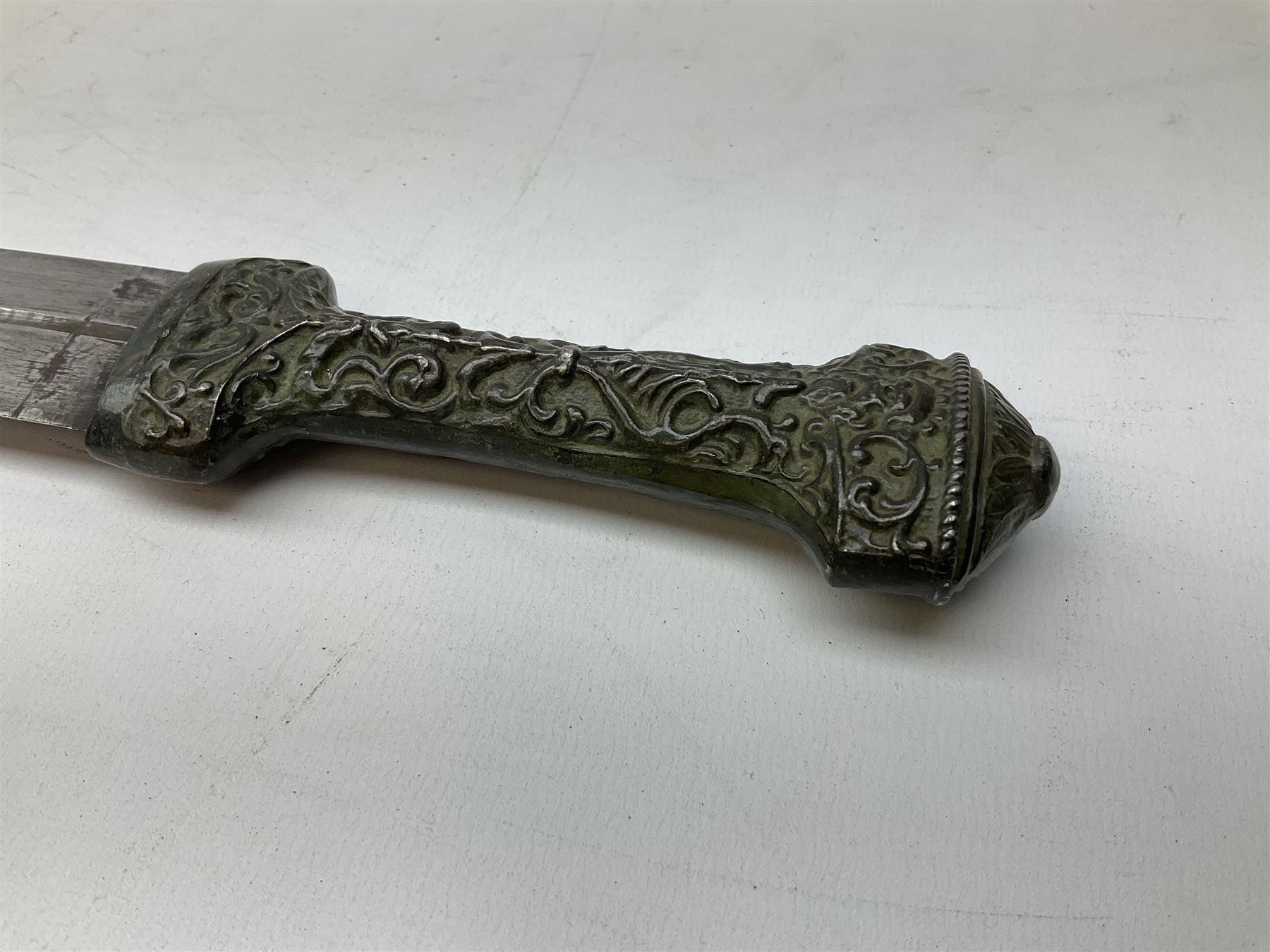 19th century Khanjali dagger, 33.5 cm double edged fullered blade with stamped makers marks, ornate cast grip, with engraved white metal scabbard, 46cm overall