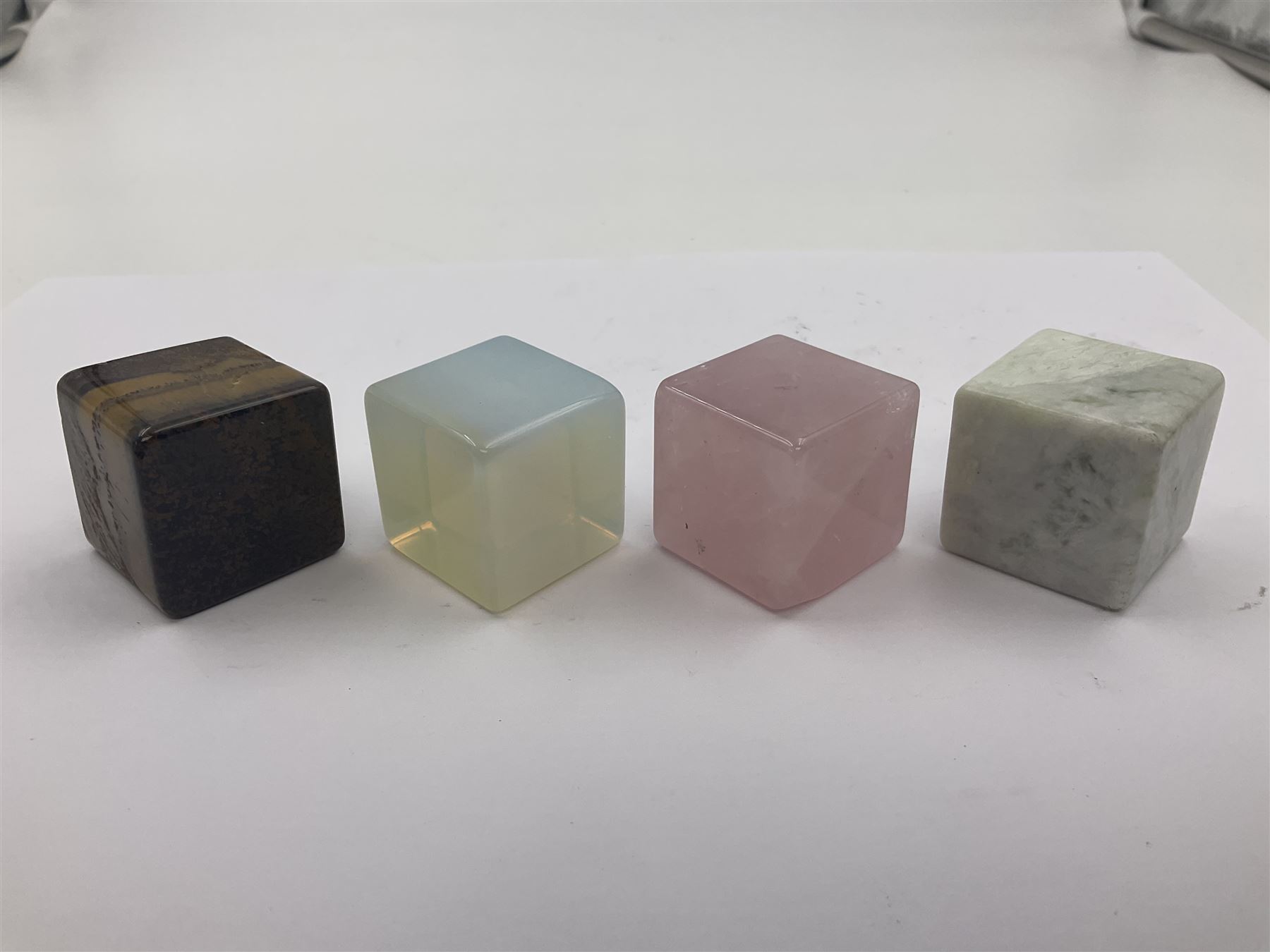 Ten cube mineral specimens, each cut and polished to highlight natural formations, including tiger eye, green aventurine, rose quartz, opalite, amethyst etc, H3cm 