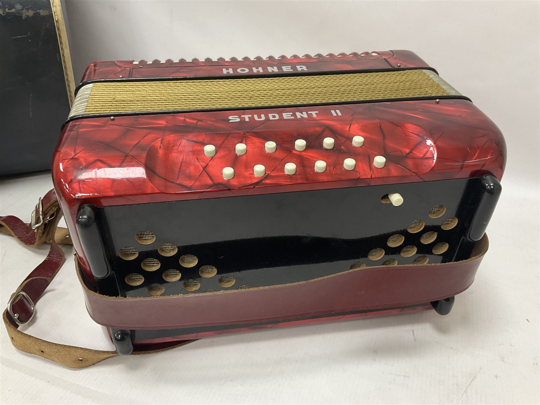 German Hohner student II compact accordion with 26 keys and 12 bass registers in a hard case With tutor