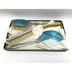 Enamel three piece dressing table set with blue guilloche enamel decoration, comprising hand mirror, hair brush and clothes brush.