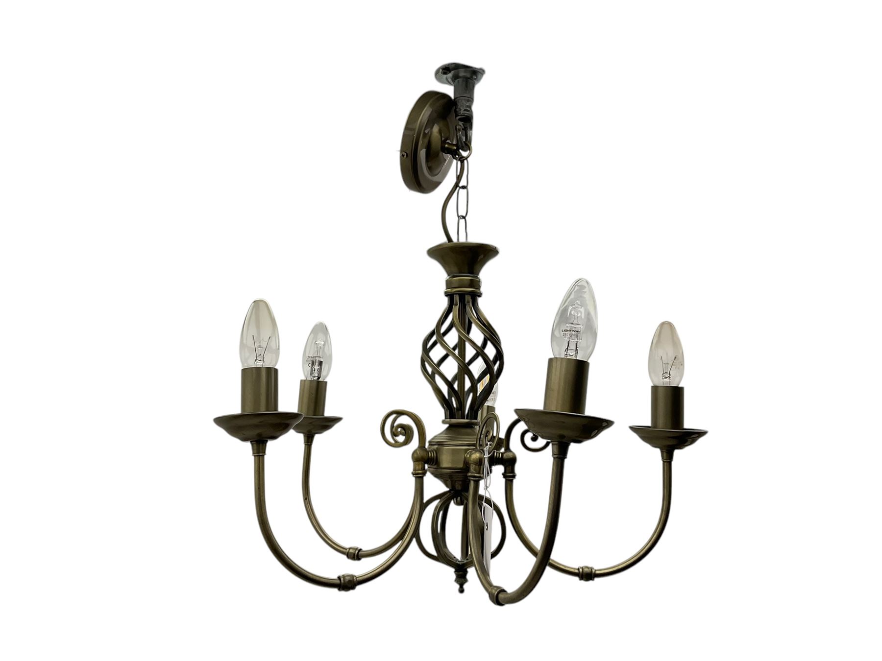 Pair of brass five-branch chandeliers, each featuring scrolling arms with candle-style light fittings, centred by a twisted openwork column, complete with ceiling roses and hanging chains