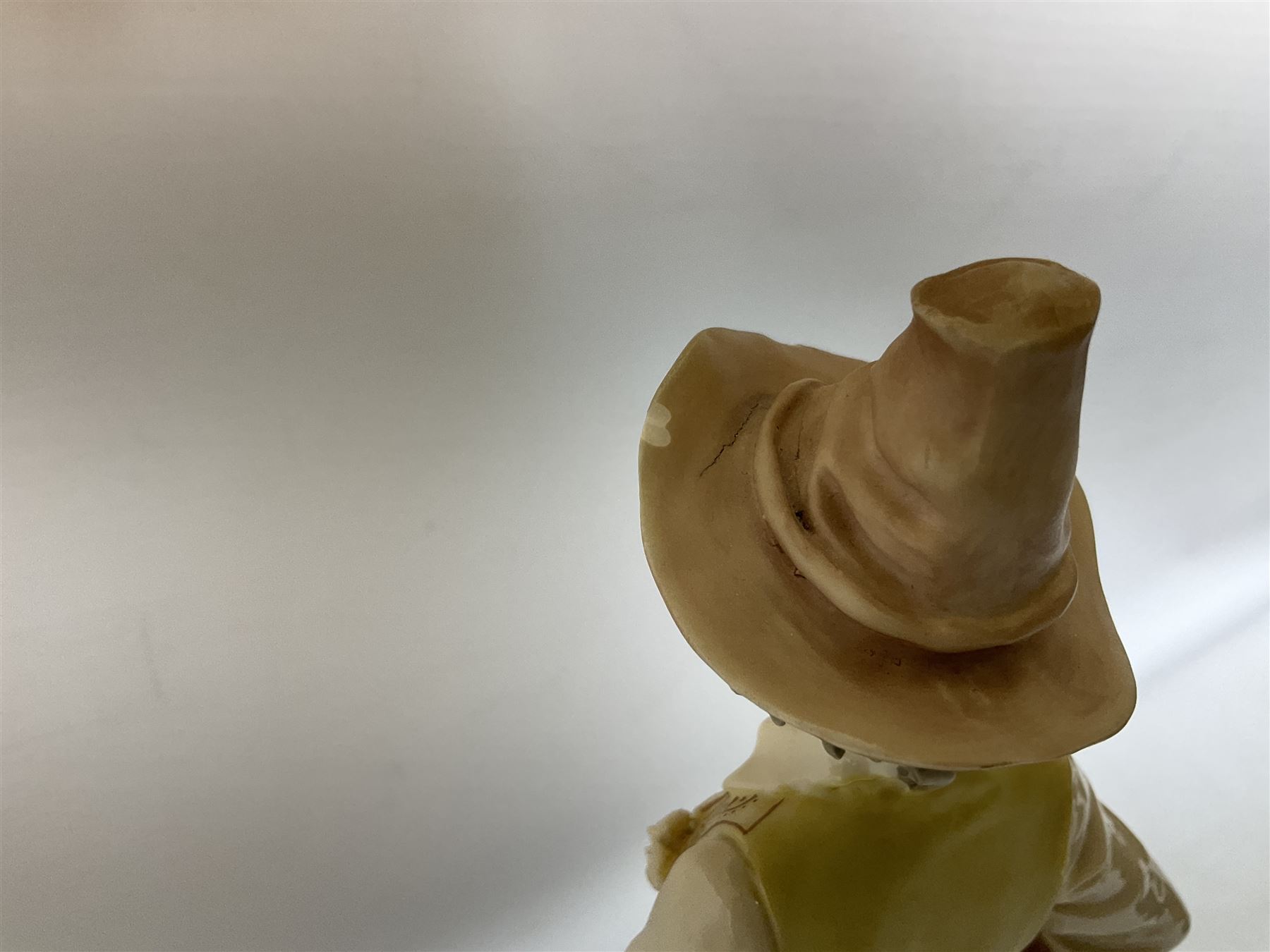 A Belcari figural table lamp, modelled as a young gent leaning upon brick wall, on turned wood base, signed, H70cm incl shade, together with bronzed figural table lamp of a lady with parasol upon ornate circular plinth base, two ceramic table lamps and another lamp (5)