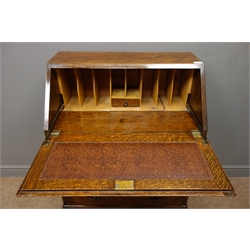  Early 20th century oak bureau, fall front enclosing fitted interior with leather inset, above three graduating drawers, on turned supports joined by square stretchers, W73cm, H101cm, D45cm  