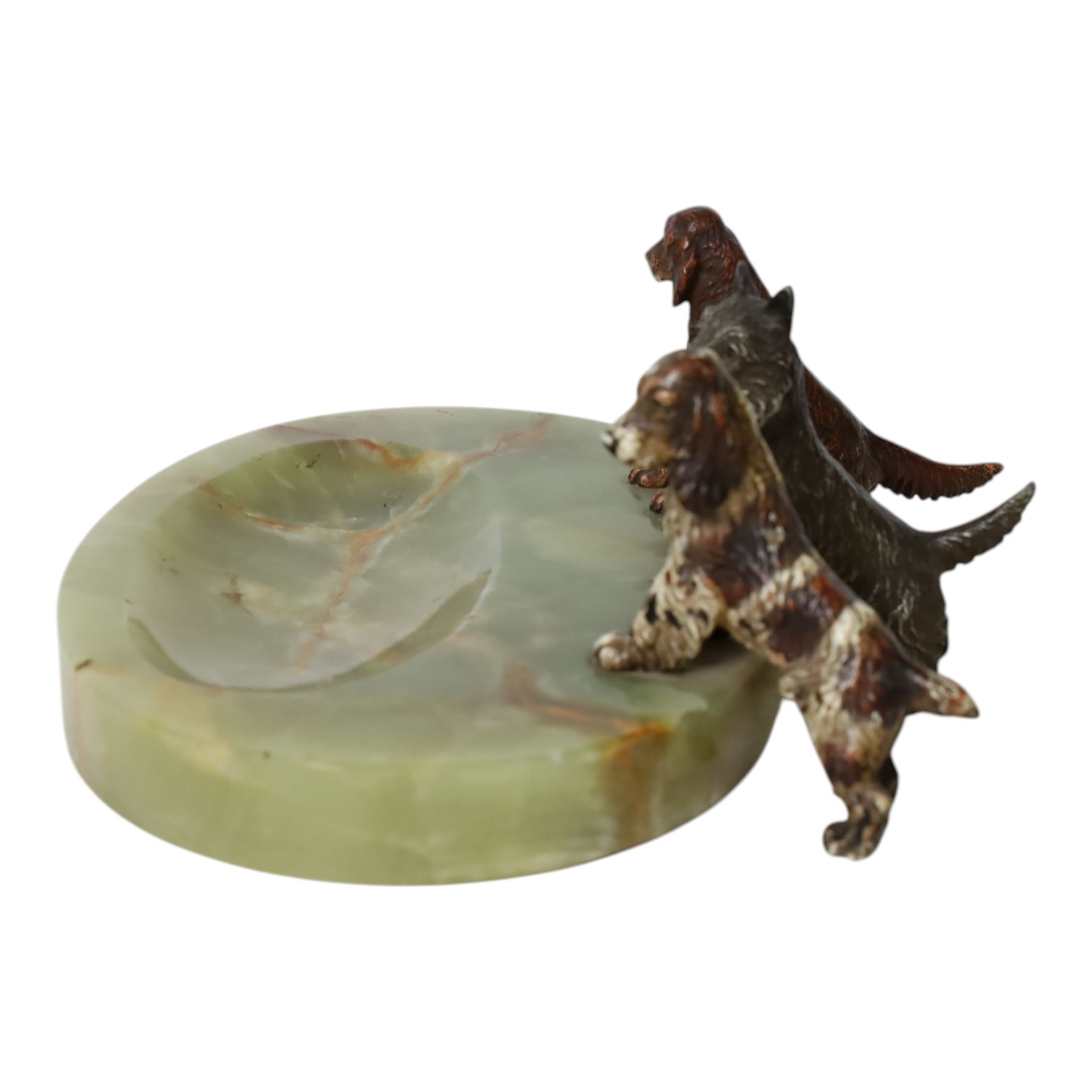 Art Deco ashtray, the oval green onyx tray with oval dished recess, the edge surmounted with three cold painted bronze dogs, comprising Irish Setter, Scottish Terrier and Springer Spaniel, each marked with incised H to base of foot, tray L17cm
