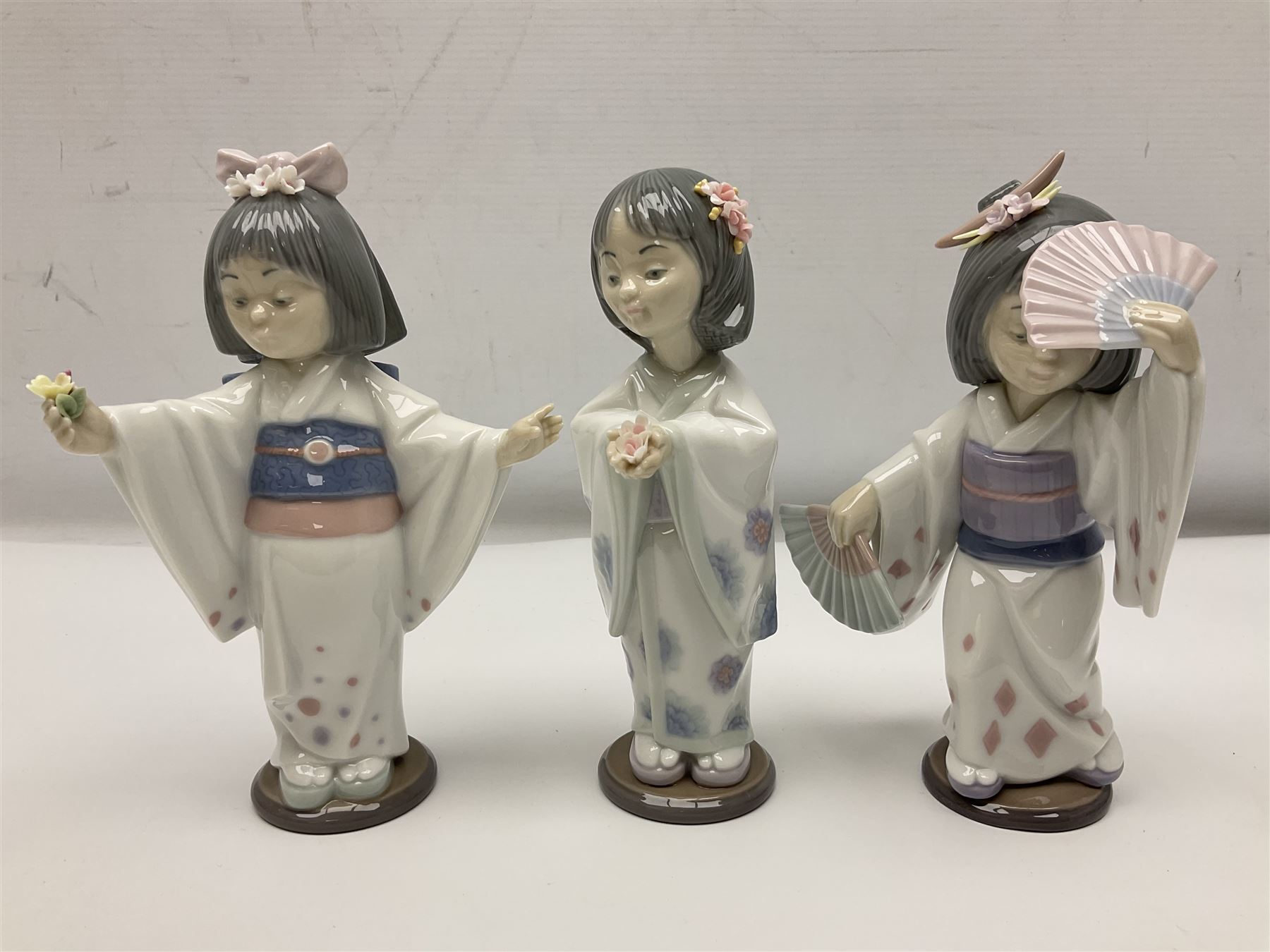 Six Lladro figures of the China doll set and Oriental doll set, comprising Playing the Flute no.6150, Bearing Flowers no.6151, Flower Gazer no. 6152, Oriental Dance no. 6230, Oriental Lantern no. 6231 and Oriental Beauty no. 6232, largest H20cm