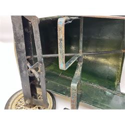 Mid 20th century pressed steel pedal car, the body painted in dark green fitted with pretend radiator to the bonnet, with spoked wheels and rubber tyres, the interior with pedals and steering wheel, L70cm