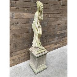 Cast stone garden figure of a bathing lady, raised on square plinth